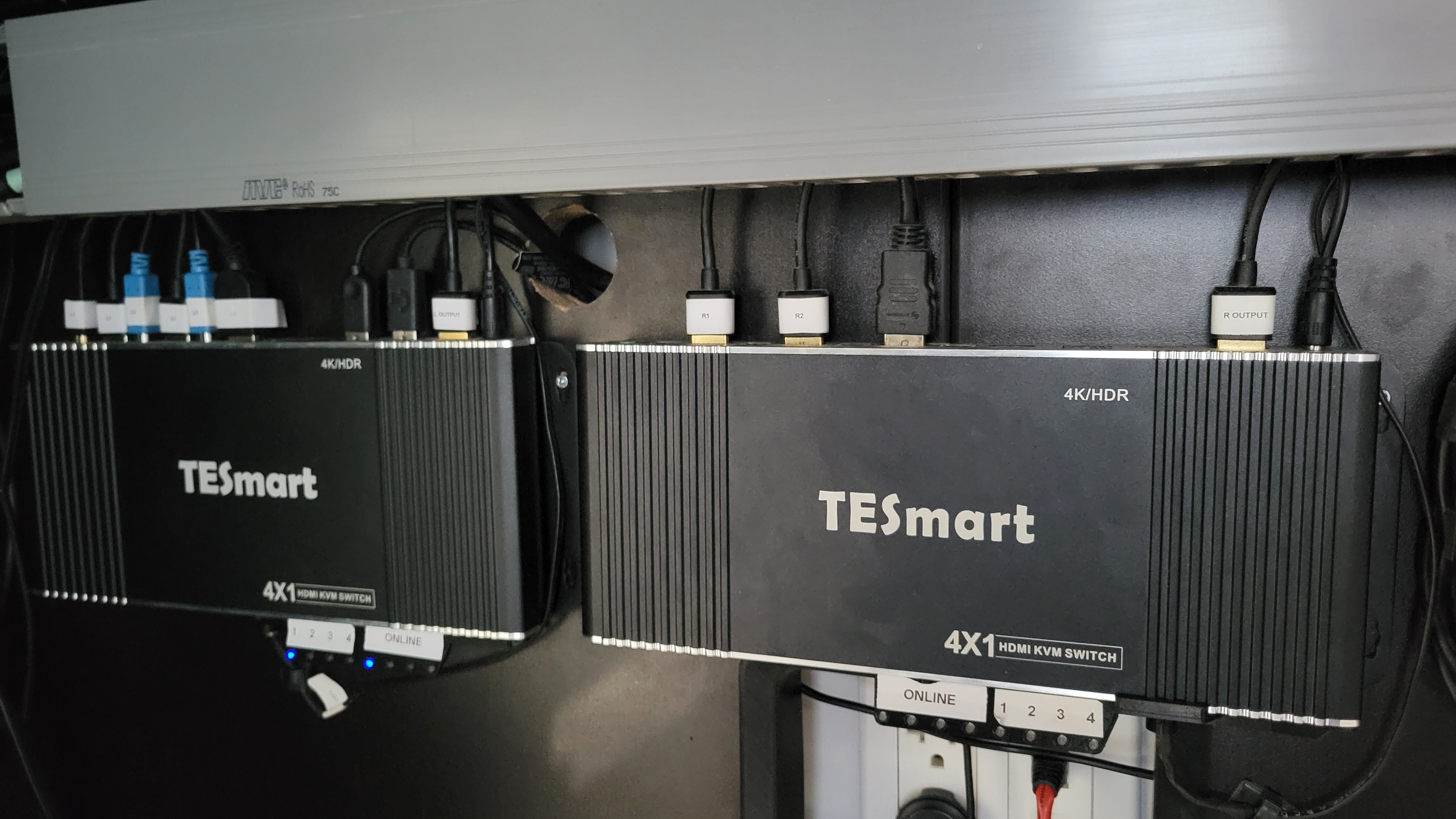 The two KVMs under the desk sit neatly out of the way. Notice the visible LED indicators